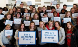 People holding up signs saying we are dementia friends